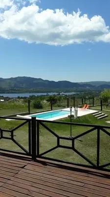 a swimming pool on the deck of a house at Cabañas Villa del Mirador in Bialet Massé