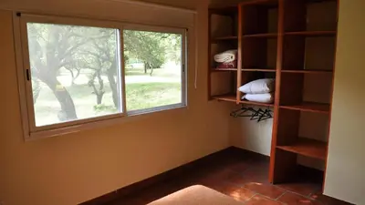 a room with a window and a book shelf at La Simona in Cortaderas