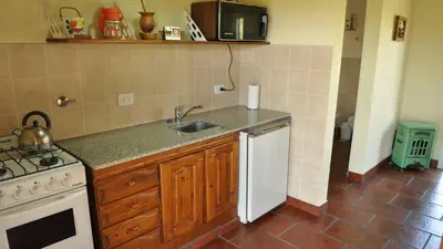 a kitchen with a sink and a stove at La Simona in Cortaderas