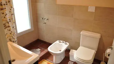 a bathroom with a toilet and a sink at La Simona in Cortaderas