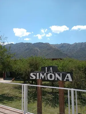 a sign that says la simona with mountains in the background at La Simona in Cortaderas
