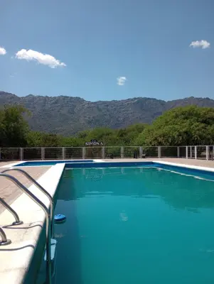 a swimming pool with mountains in the background at La Simona in Cortaderas