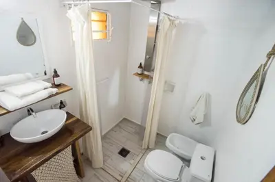 a bathroom with a toilet and a sink and a shower at Posada Casa de Piedra in Los Reartes