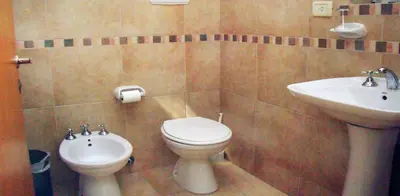 a bathroom with a toilet and a sink at Hotel Playa in Villa Carlos Paz