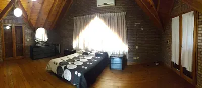 a room with a large bed in a brick wall at Chalet Nuevo Amanecer in Merlo