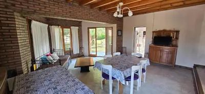 a living room with a table and a couch at Chalet Nuevo Amanecer in Merlo