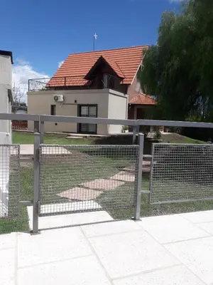 a fence in front of a house at Chalet Nuevo Amanecer in Merlo