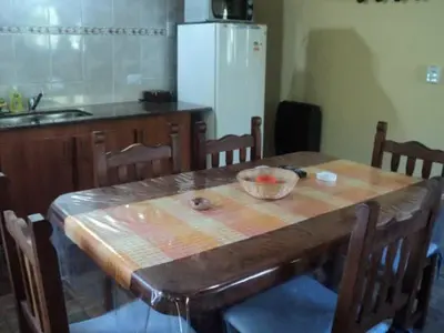 a kitchen with a wooden table with a bowl on it at Cabañas Toay Merlo San Luis in Merlo
