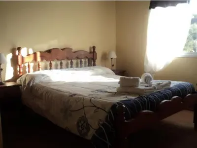a bedroom with a bed with towels on it at Cabañas Toay Merlo San Luis in Merlo