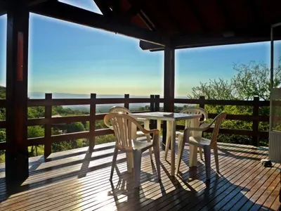 a table and chairs on a deck with a view at Cabañas Toay Merlo San Luis in Merlo
