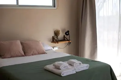 a bedroom with a bed with towels on it at Las Quimeras in Nono