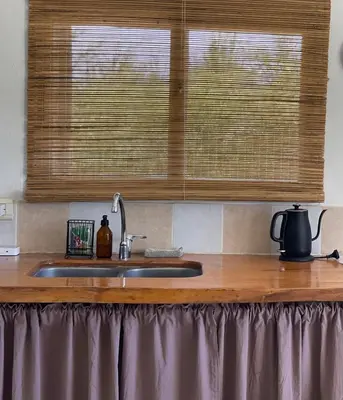 a kitchen counter with a sink and a window at Las Quimeras in Nono