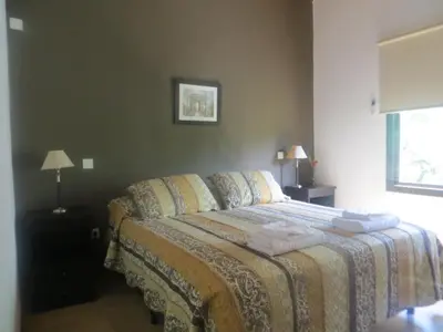 a bedroom with a bed with two towels on it at Reina de las Cortaderas in Merlo