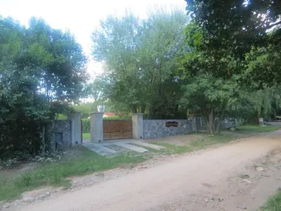 a house on the side of a dirt road at Reina de las Cortaderas in Merlo