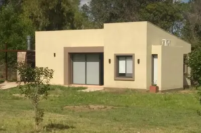 a small house in the middle of a field at Reina de las Cortaderas in Merlo