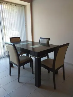 a dining room table with two chairs and a black table at Reina de las Cortaderas in Merlo
