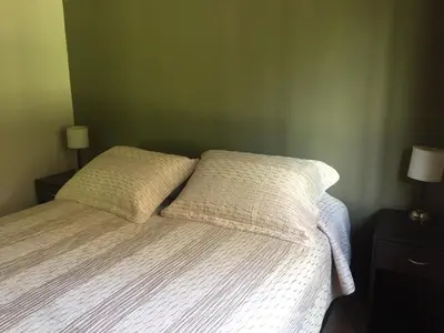 a bedroom with a bed with two pillows on it at Reina de las Cortaderas in Merlo