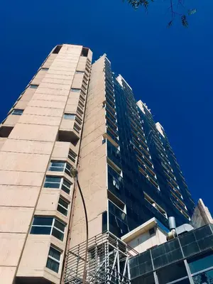 a tall building with a blue sky in the background at Departamento Premiun En Zona Centro in Cordoba