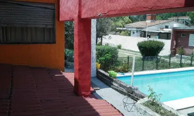 a view of a swimming pool from a house at Amanitas Hotel in Villa Carlos Paz