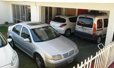 a group of three cars parked in a garage at Amanitas Hotel in Villa Carlos Paz