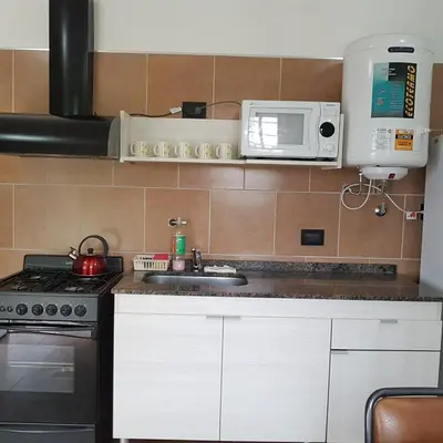 a kitchen with a sink and a microwave at Altos del Lago in Villa Carlos Paz
