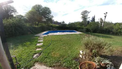 a yard with a swimming pool in the grass at casa de campo en Villa Los Aromos Cordoba in Villa Los Aromos