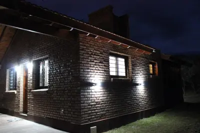 a brick building with lights on it at night at Casa Crisolito in Merlo