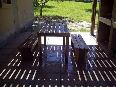 a picnic table and two benches on a patio at El Refugio Casas de Campo in Villa General Belgrano