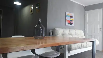 a wine bottle sitting on top of a wooden table at Complejo Joansa in Villa Santa Cruz del Lago