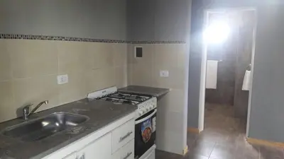 a kitchen with a sink and a stove at Complejo Joansa in Villa Santa Cruz del Lago