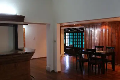 a dining room and living room with a table and chairs at Espectacular casa in Cordoba