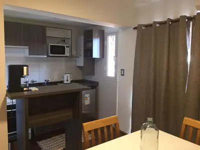 a small kitchen with a table and a counter top at Apartamento Carlucci in Cordoba