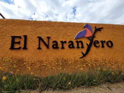 a sign for the al marian zoo with a bird on it at El Naranjero Apart in Carpintería