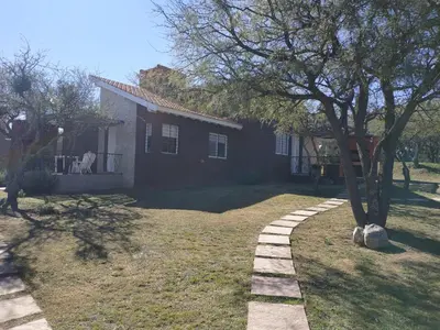 a house with a walkway in front of a yard at El Naranjero Apart in Carpintería