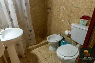 a bathroom with a toilet and a sink at Cabaña El Chaparral Villa Dolores, Traslasierra 1 in Piedra Pintada