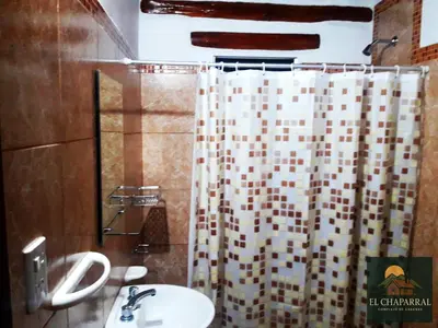 a bathroom with a sink and a shower curtain at Cabaña El Chaparral Villa Dolores, Traslasierra 1 in Piedra Pintada