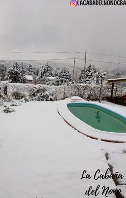 a swimming pool covered in snow in a yard at La cabaña del nono in Potrero de Garay