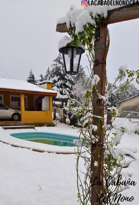 a light pole with snow on top of it at La cabaña del nono in Potrero de Garay