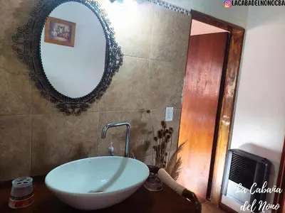 a bathroom with a sink and a mirror on the wall at La cabaña del nono in Potrero de Garay