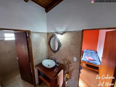 a bathroom with a sink and a mirror at La cabaña del nono in Potrero de Garay