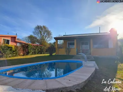 a swimming pool in front of a house at La cabaña del nono in Potrero de Garay