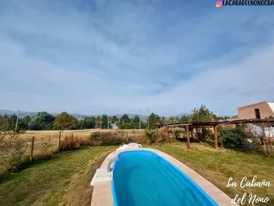 a swimming pool in the middle of a field at La cabaña del nono in Potrero de Garay