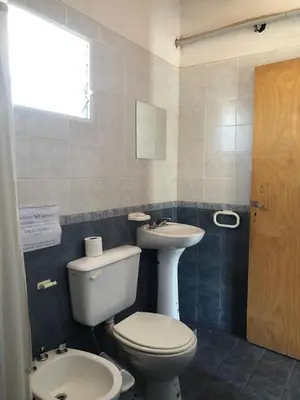 a bathroom with a toilet and a sink at El Viejo Vagon in Mina Clavero