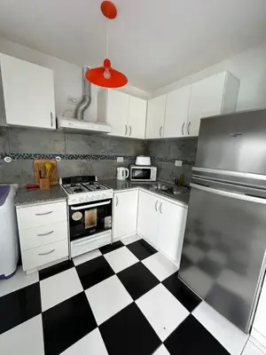 a kitchen with a black and white checkered floor at La Francisca in Almafuerte