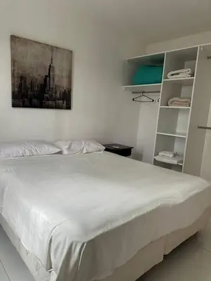 a bedroom with a white bed with a picture on the wall at La Francisca in Almafuerte