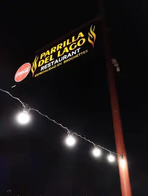 a sign for a pizza restaurant on a pole with lights at La Francisca in Almafuerte