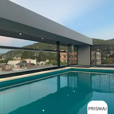 a swimming pool with a view of a building at Edificio PRISMA I in Villa Carlos Paz