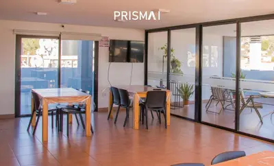 a dining room with two tables and chairs at Edificio PRISMA I in Villa Carlos Paz