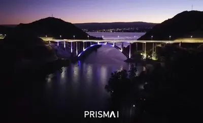 a bridge over a river at night at Edificio PRISMA I in Villa Carlos Paz