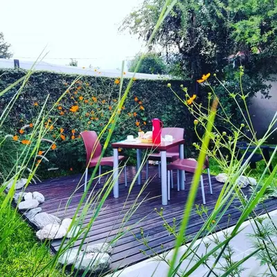 a table and chairs sitting on a wooden deck at Hostería Boutique El Puente Adults Only in Merlo